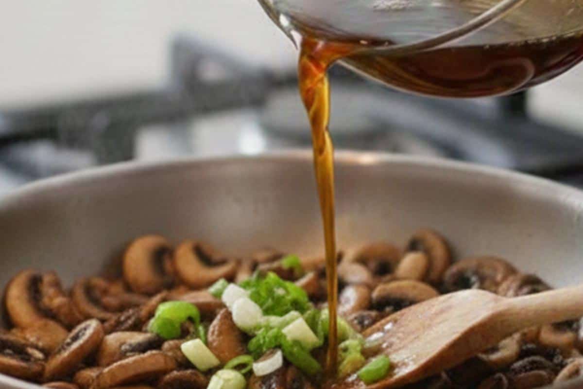 Pouring the in the reserved beer marinade in the pan with mushroom s and shallots. - 8