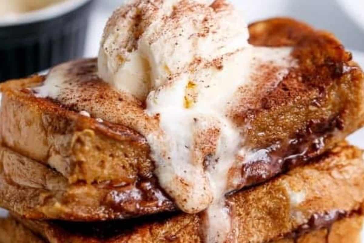 Top each Coffee French Toast with coffee cream, a scoop of ice cream if you’d like, and a sprinkle of chocolate dusting powder. - 10