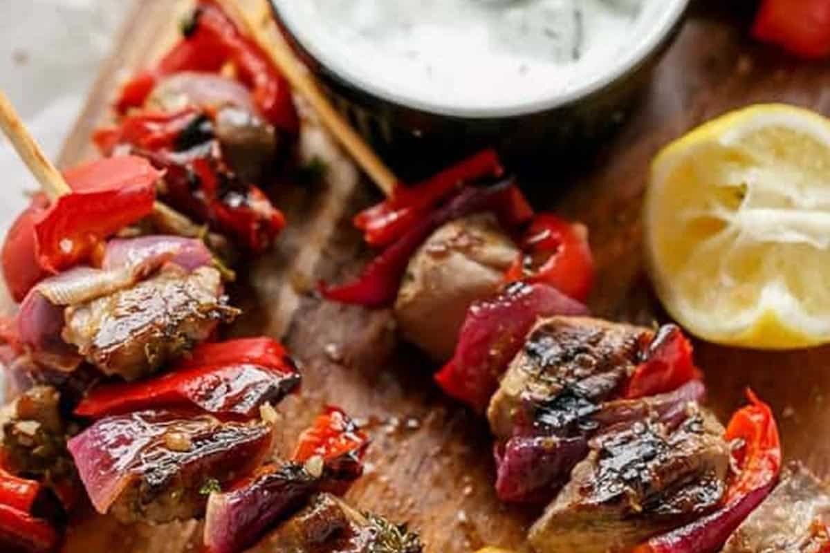 Close-up shot of Greek Lamb Souvlaki with a Garlic Yogurt Dip.