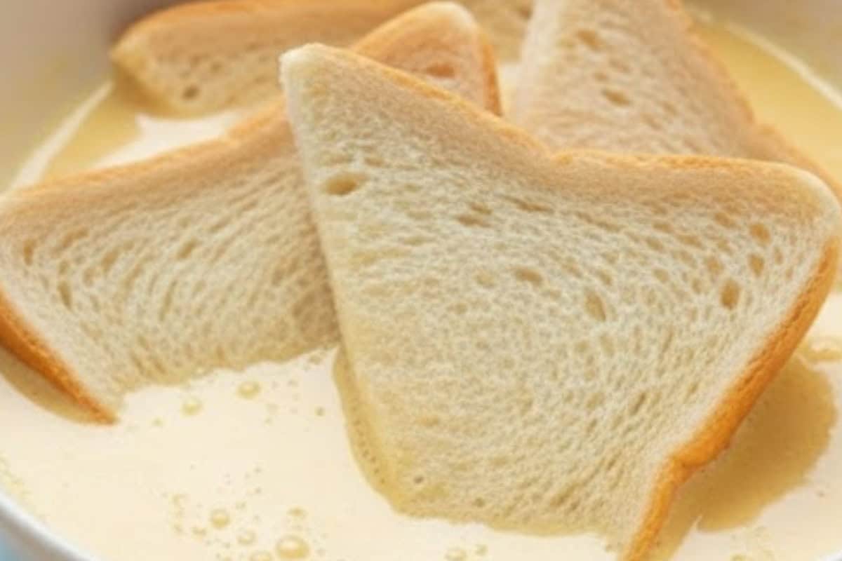 Dip each slice of bread into the egg mixture, pressing gently on both sides so the custard soaks. - 4