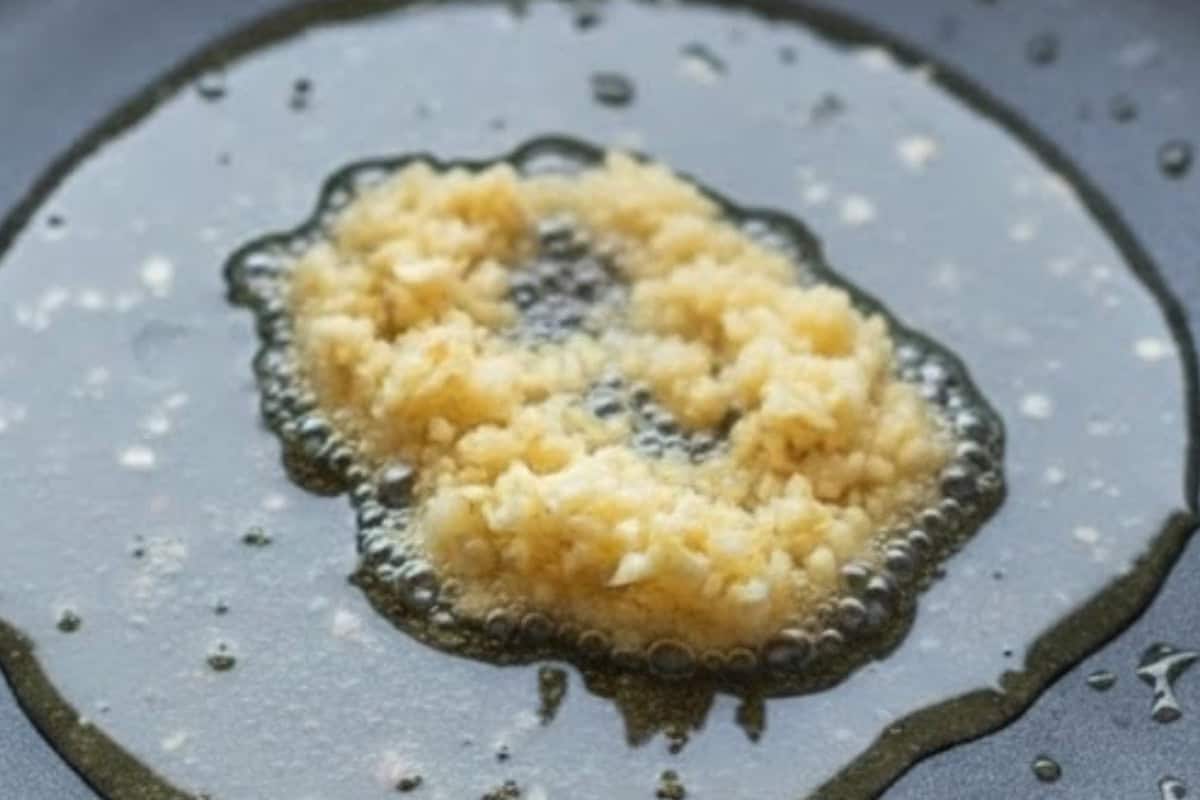 Turn the heat up to high and add the garlic, stir-frying for about a minute until fragrant and lightly golden.