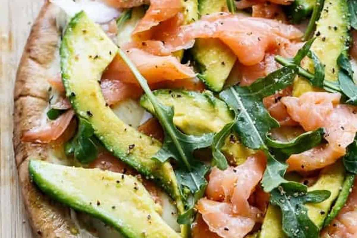 Close-up shot of Smoked Salmon and Avocado Pizza.