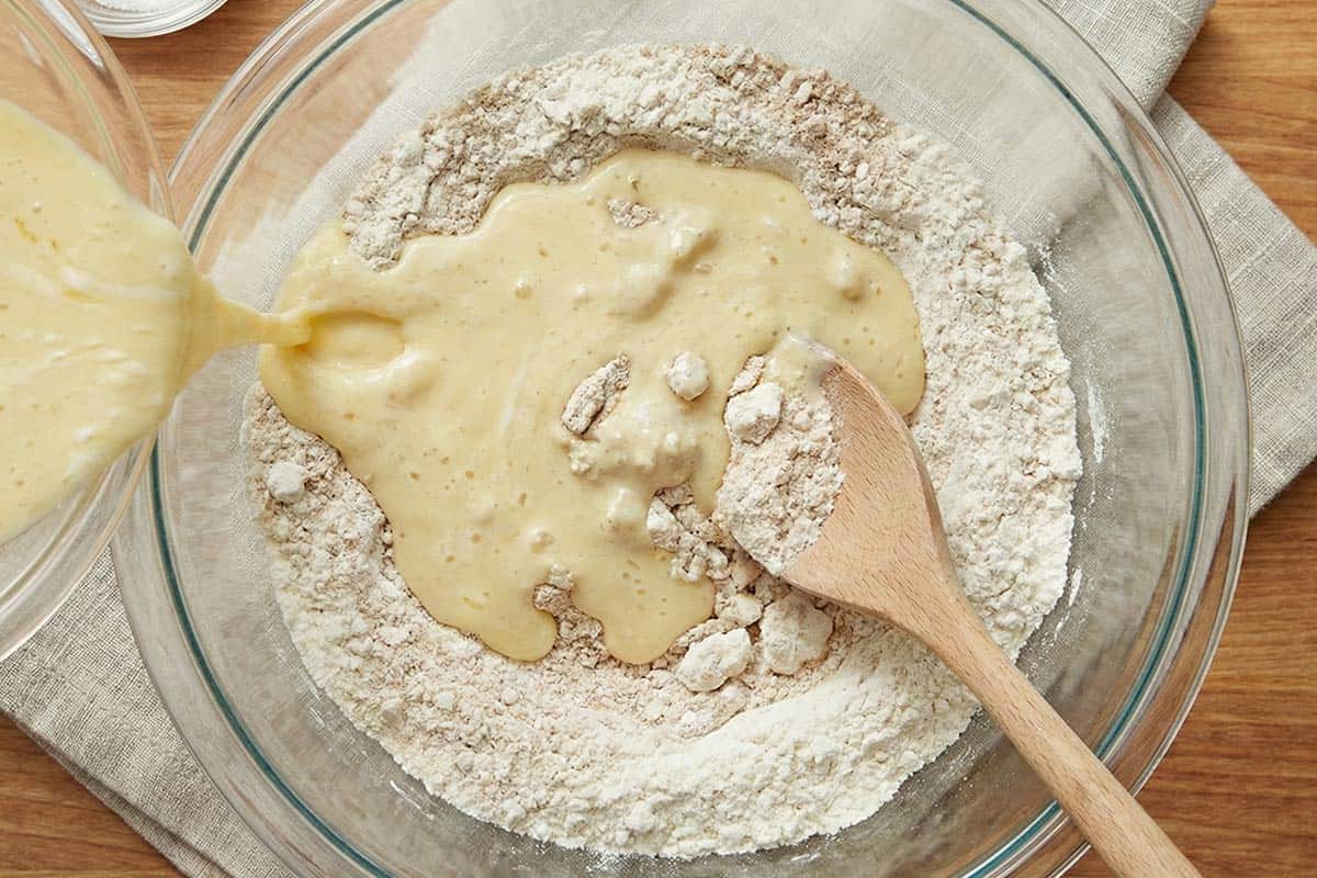 Pouring the yogurt mixture over the dry ingredients. - 5