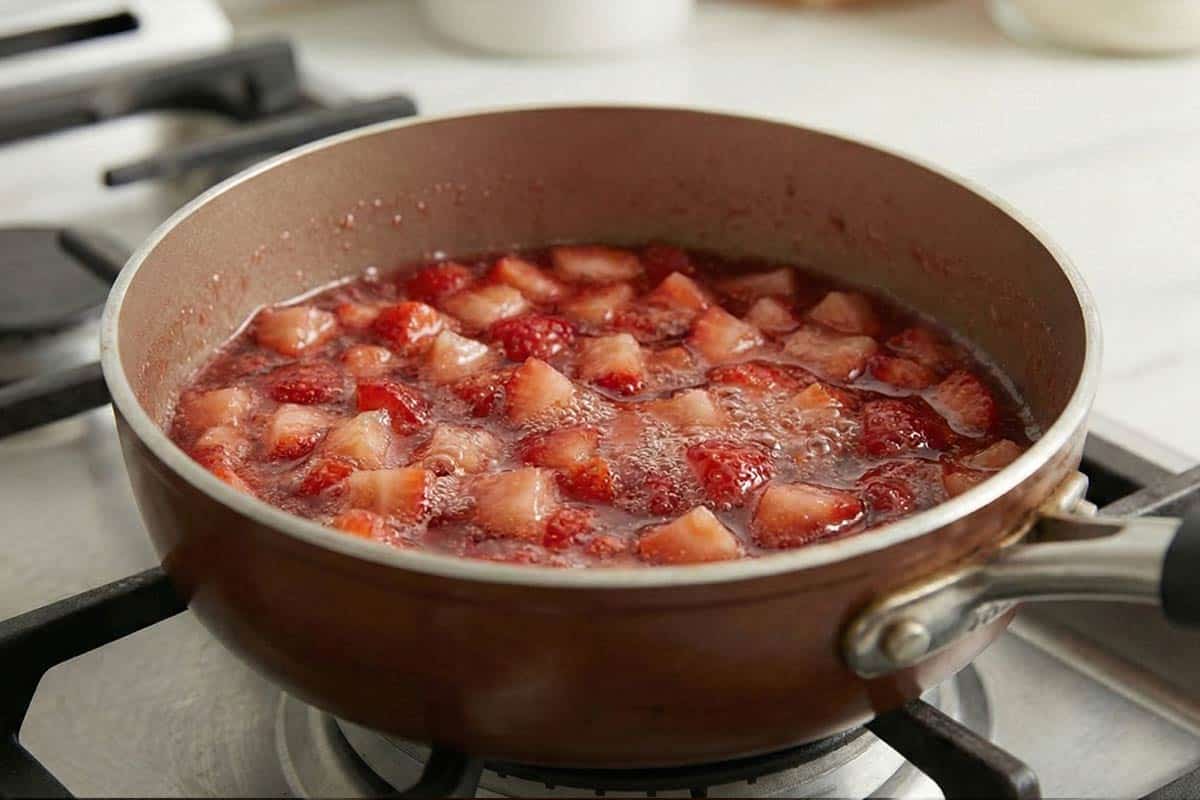 Simmering the strawberries, sugar, water and vanilla in a small saucepan. - 8