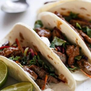 Korean Bulgogi Bbq Beef Tacos with lemon wedges