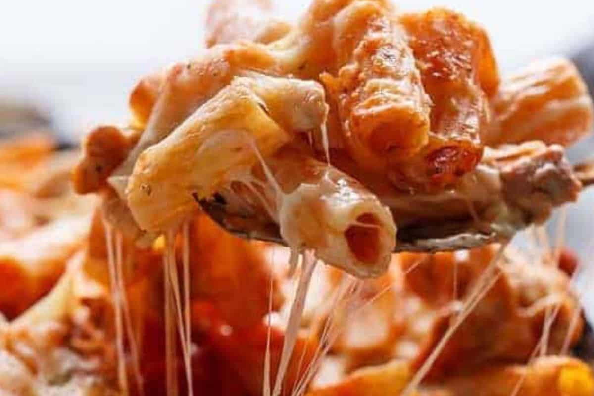 Add the cooked pasta to the chicken and sauce. Stir through half of the mozzarella cheese.