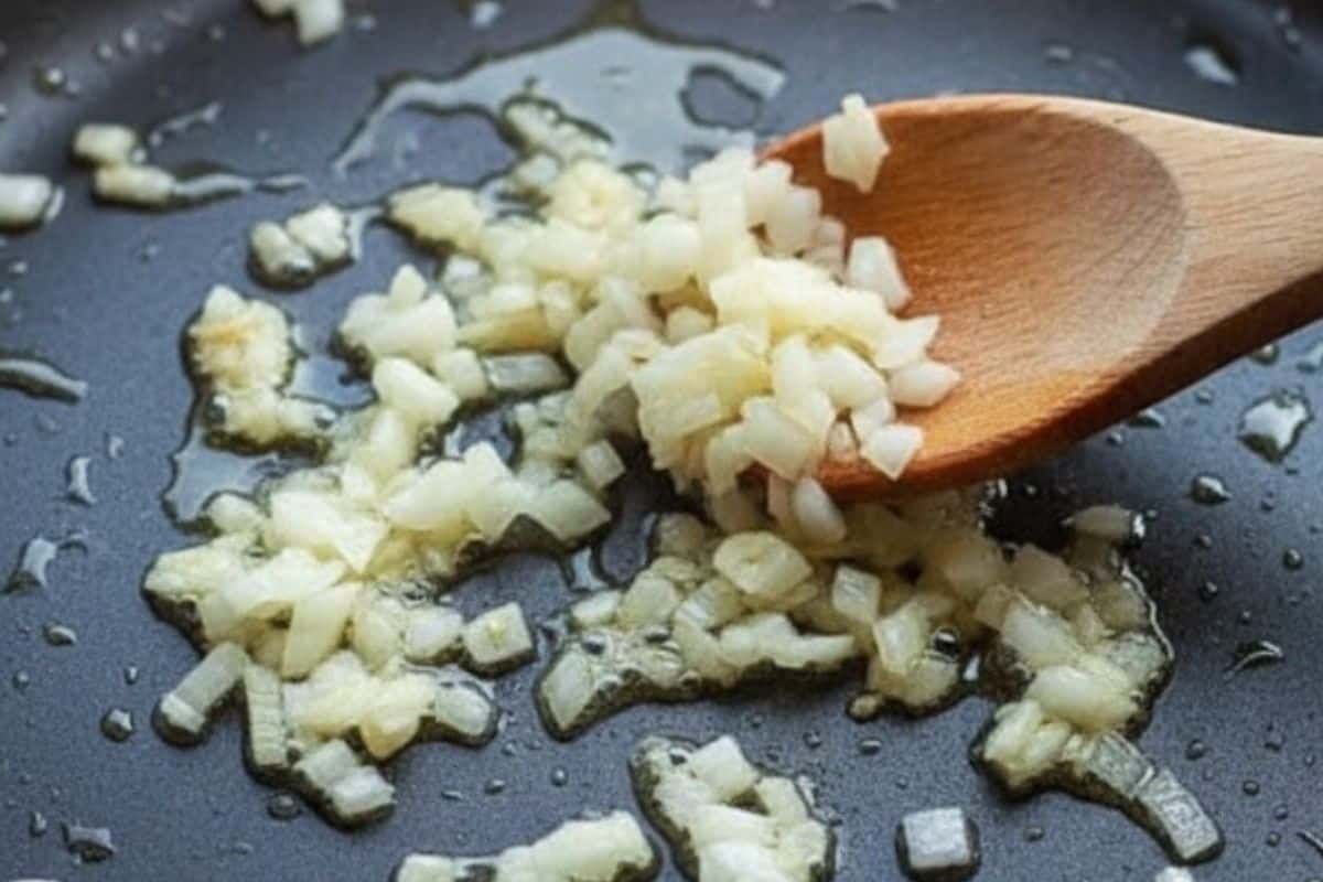 Heat olive oil in a skillet and cook the onion and garlic until soft and fragrant.