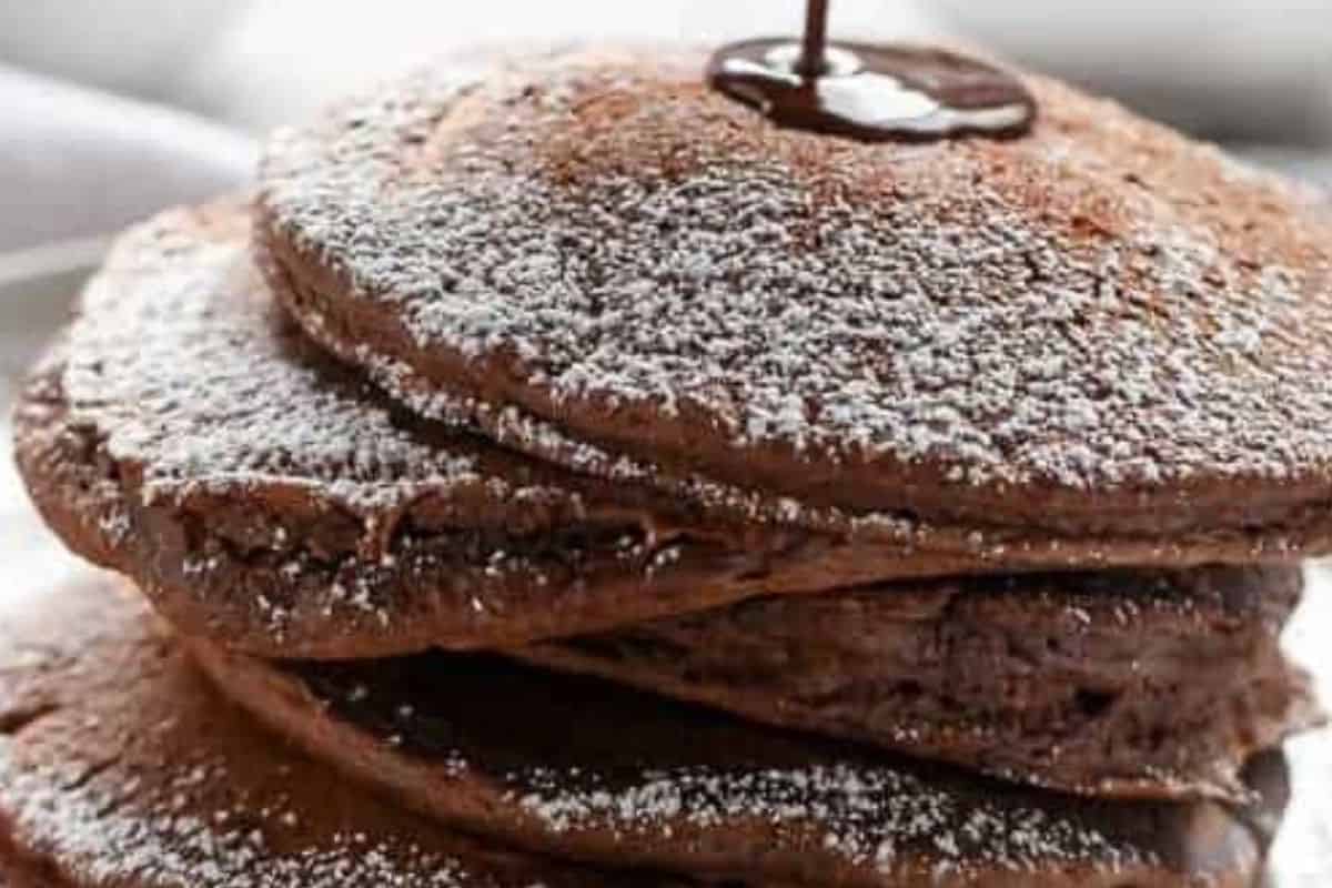 Melt the chocolate, stir until smooth, whisk in the milk to form a creamy sauce and drizzle with icing sugar