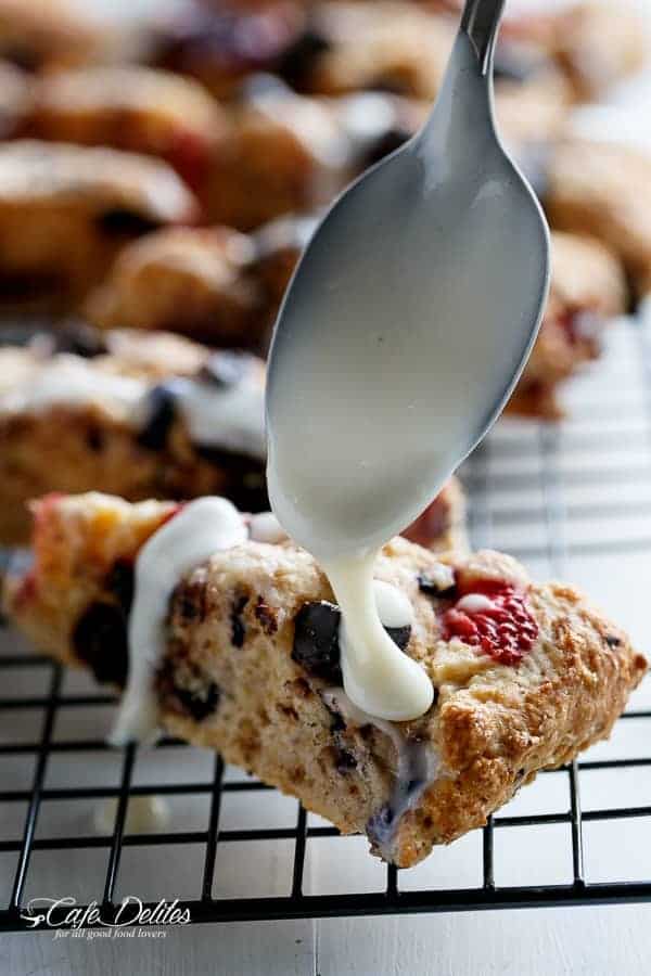 Mixed Berry and Chocolate Chunk Buttermilk Scones with a Cream Cheese Glaze | https://cafedelites.com