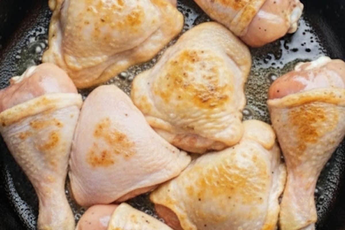Add chicken thighs and drumsticks to the skillet and fry for 3–4 minutes per side.