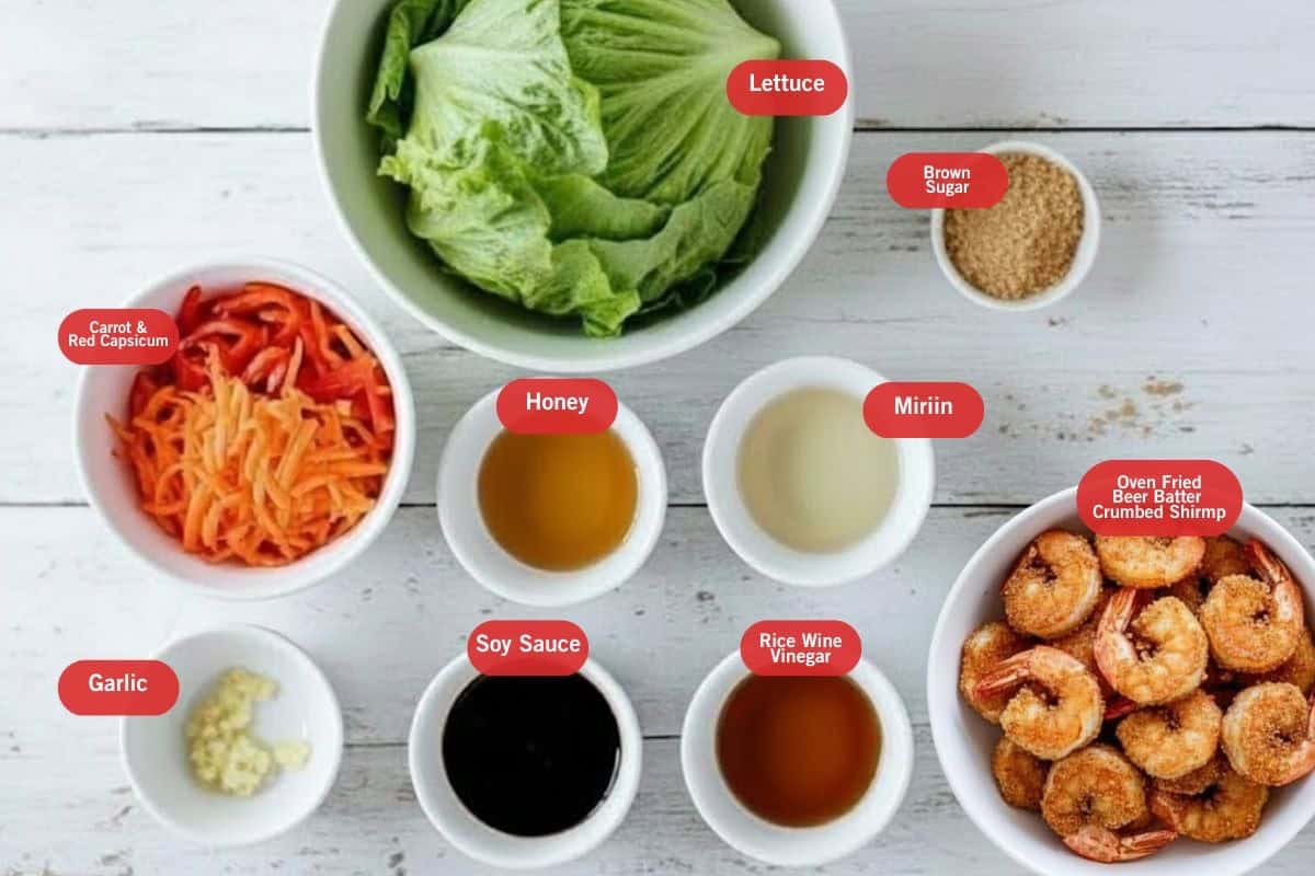 Flat lay photo of lettuce, brown sugar, oven fried beer batter, crumbed shrimp, rice wine vinegar, soy sauce, honey, carrot and red capsicum, garlic - 2