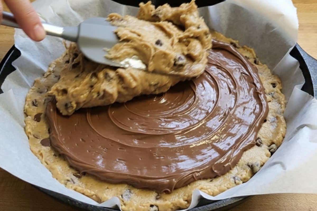 Layering the dough in the skillet. - 6