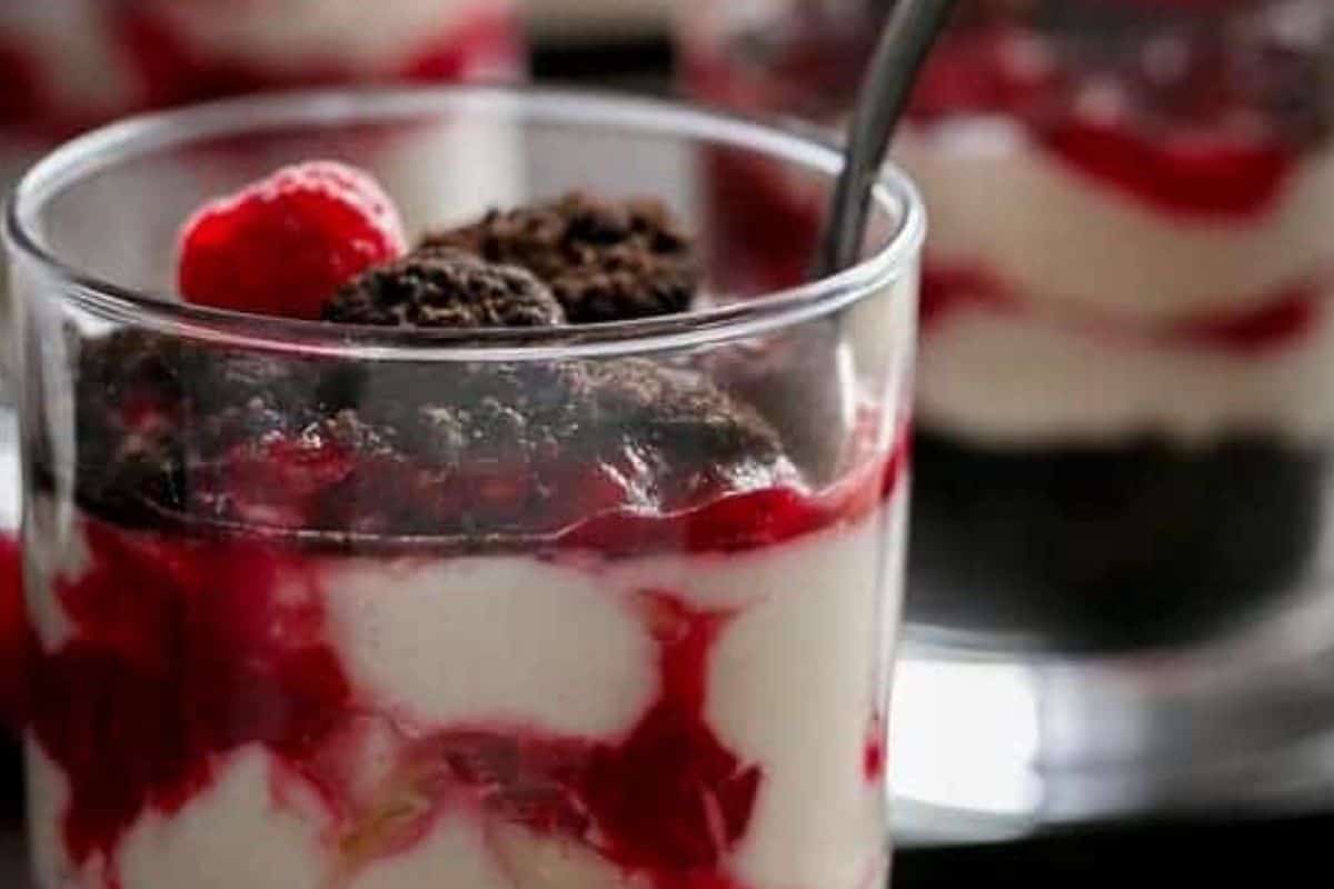 Put half of the crushed Oreos into the base of each glass, followed by half of the cheesecake mixture and half of the raspberry sauce. - 5