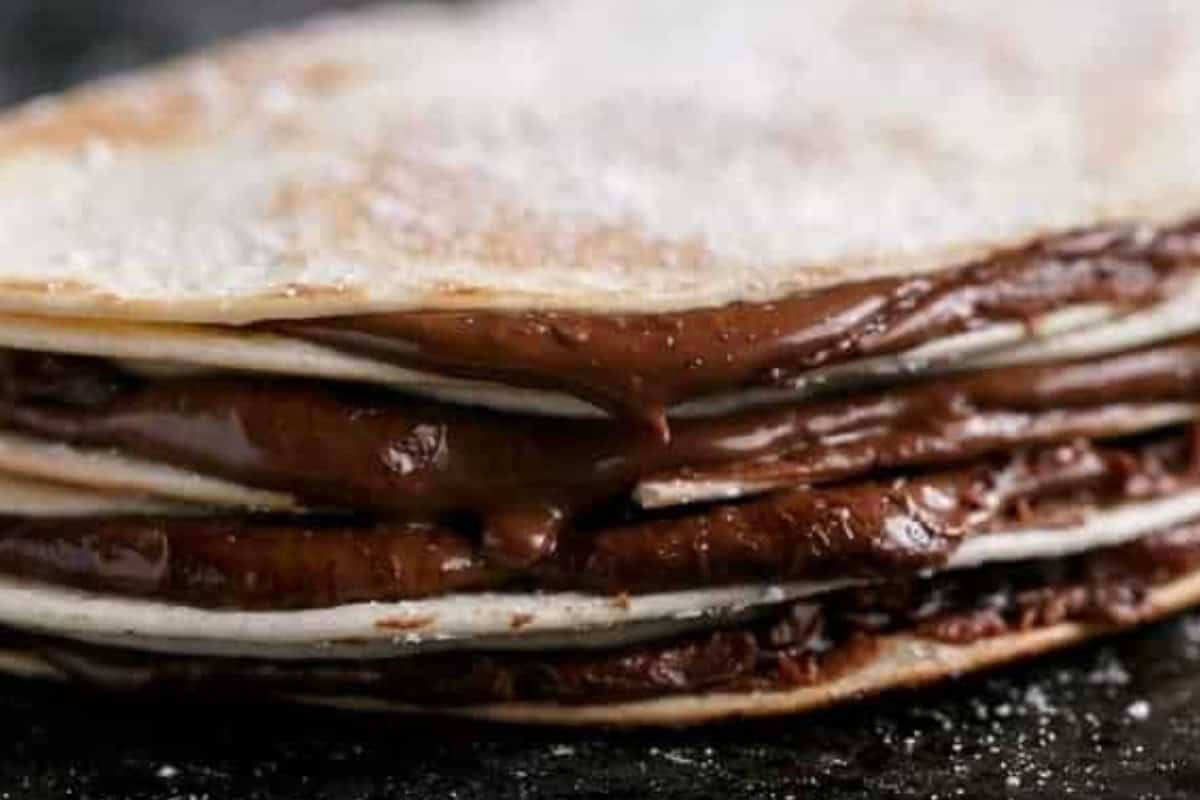 Warm a nonstick skillet over medium heat and mist with cooking oil spray. Spread 2 tablespoons Nutella over half of each mini tortilla, then fold to seal.