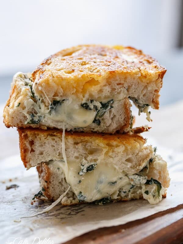 Spinach and Ricotta Grilled Cheese stack on each other on a plate
