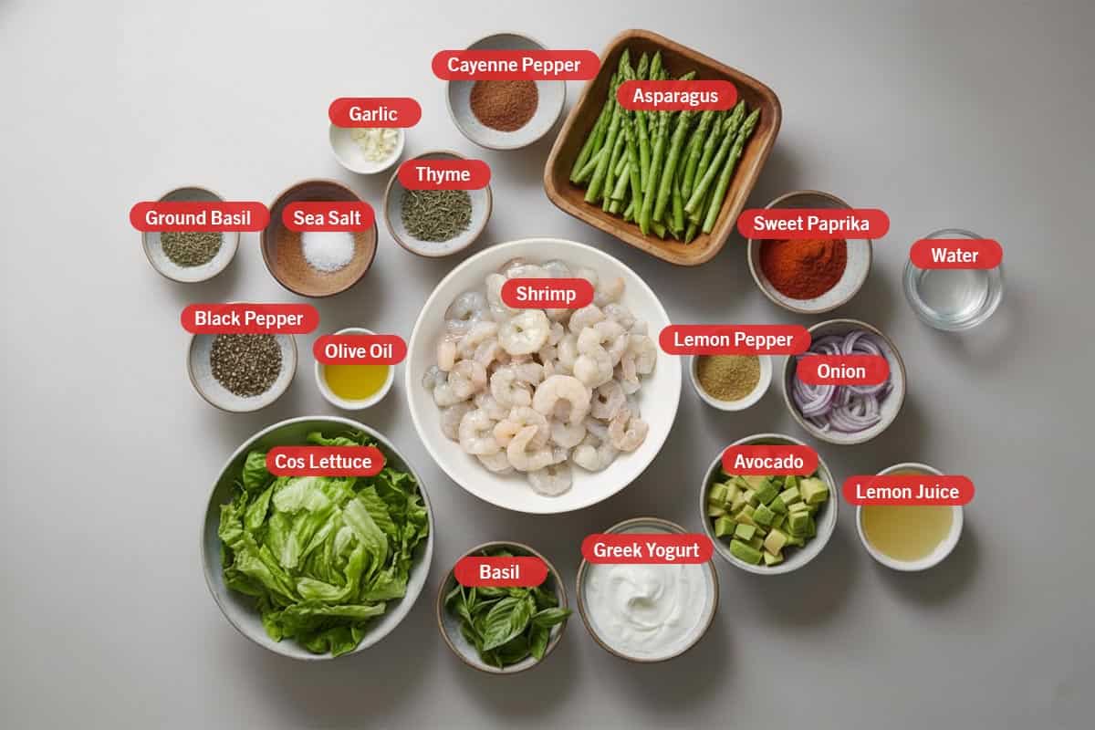 Top shot of ingredients: cayenne pepper, asparagus, sweet paprika, water, lemon pepper, onion, avocado, lemon juice, greek yogurt, basil, cos lettuce, shrimp, olice oil, black pepper, ground basil, sea salt, thyme, and garlic. - 2