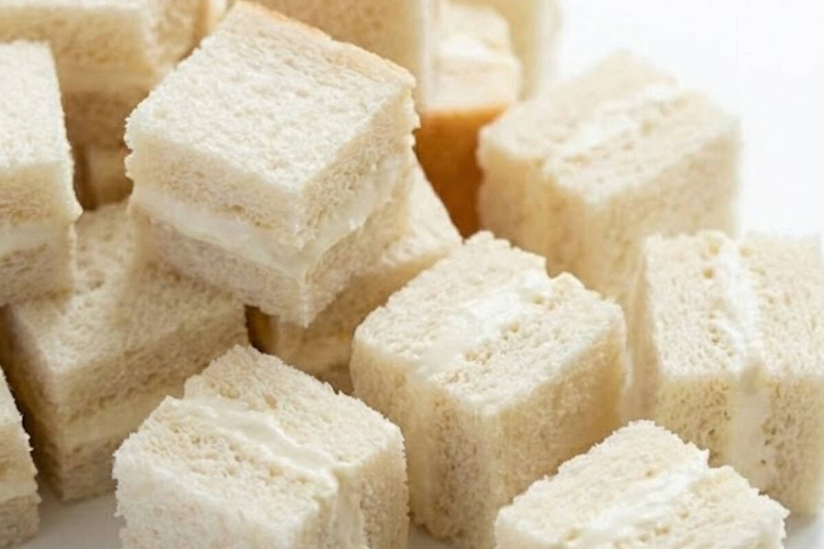 Spread the cheesecake mixture over one side of each slice of bread, sandwich them together in pairs and cut them into small one inch cubes. - 5