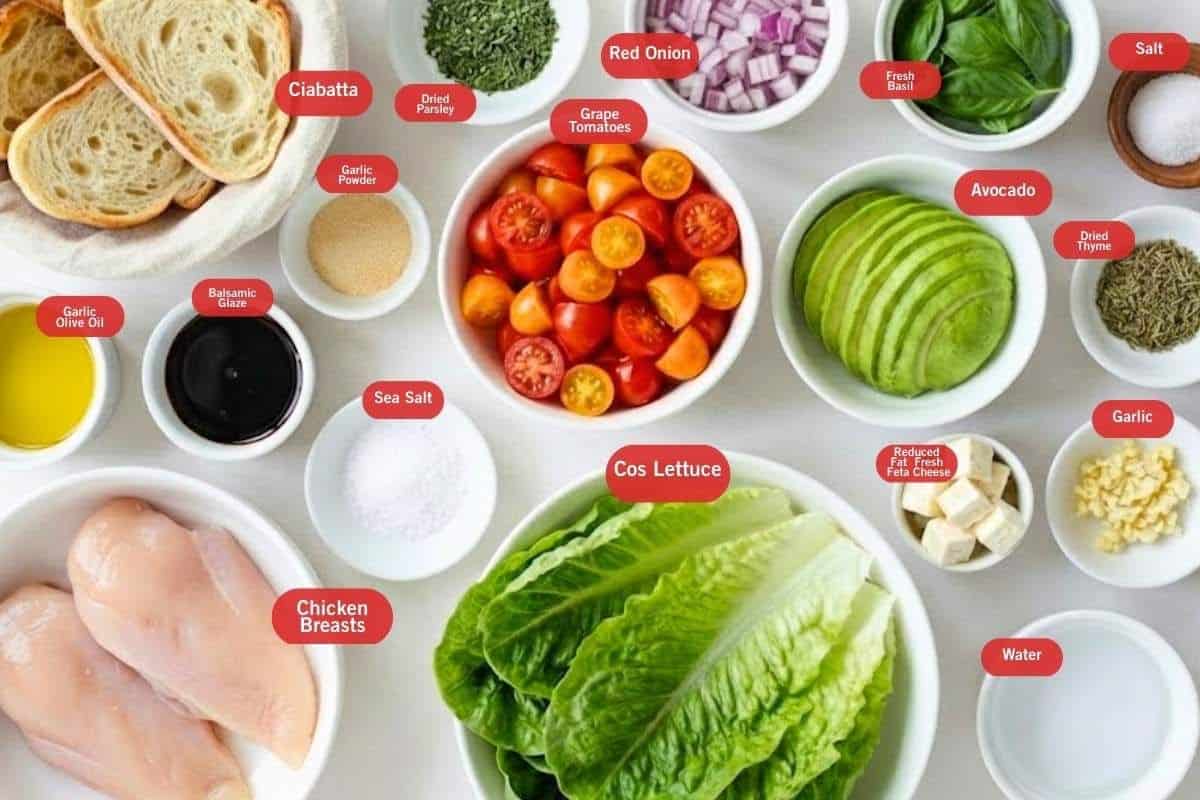 Flat lay photo of ingredient shot of ciabatta, dried parsley, red onion, fresh basil, salt, dried thyme, avocado slices, garlic, water, cos lettuce, reduced fat fresh feta cheese, sea salt, grape tomatoes, garlic powder, garlic olive oil, chicken breasts, balsamic glaze  - 2