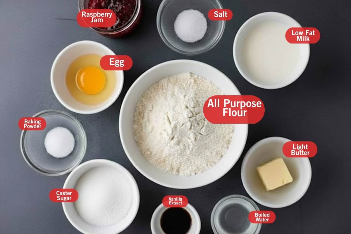 Flat lay photo of ingredient shot of raspberry jam, salt, low fat milk, all purpose flour, egg, light butter, boiled water, vanilla extract, caster sugar, baking powder