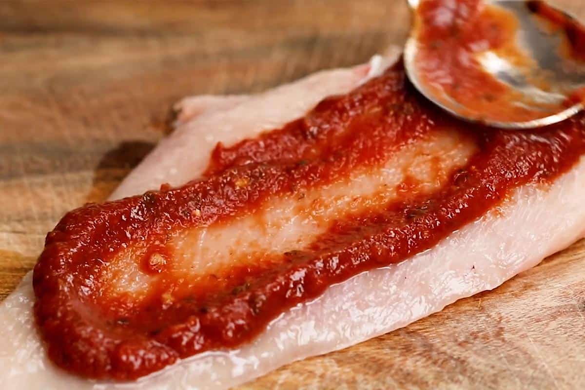 Spreading 1 tablespoon of tomato paste over one side of each fillet. - 4