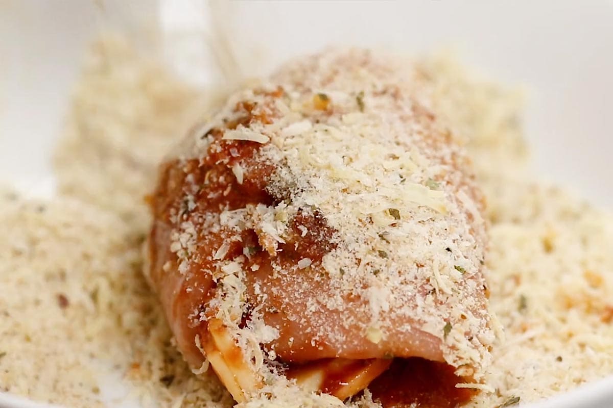 Coating the chicken in breadcrumbs. - 8