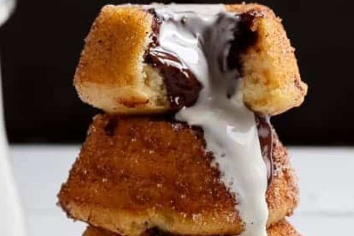 Cut a small indent on top, fill with ganache and serve with cream.
