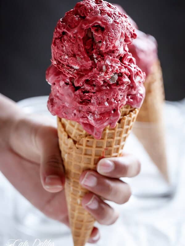 Red Velvet Cookie Dough Frozen Yogurt with a Vanilla Bean Cream Cheese Swirl on a cone