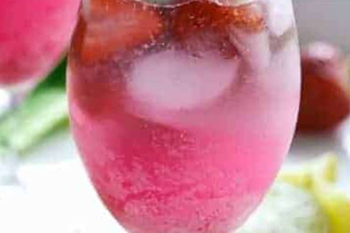 Spoon the cooled strawberry syrup into each glass, add two lime wedges per glass, pour in the coconut rum, and fill with ice. - 7