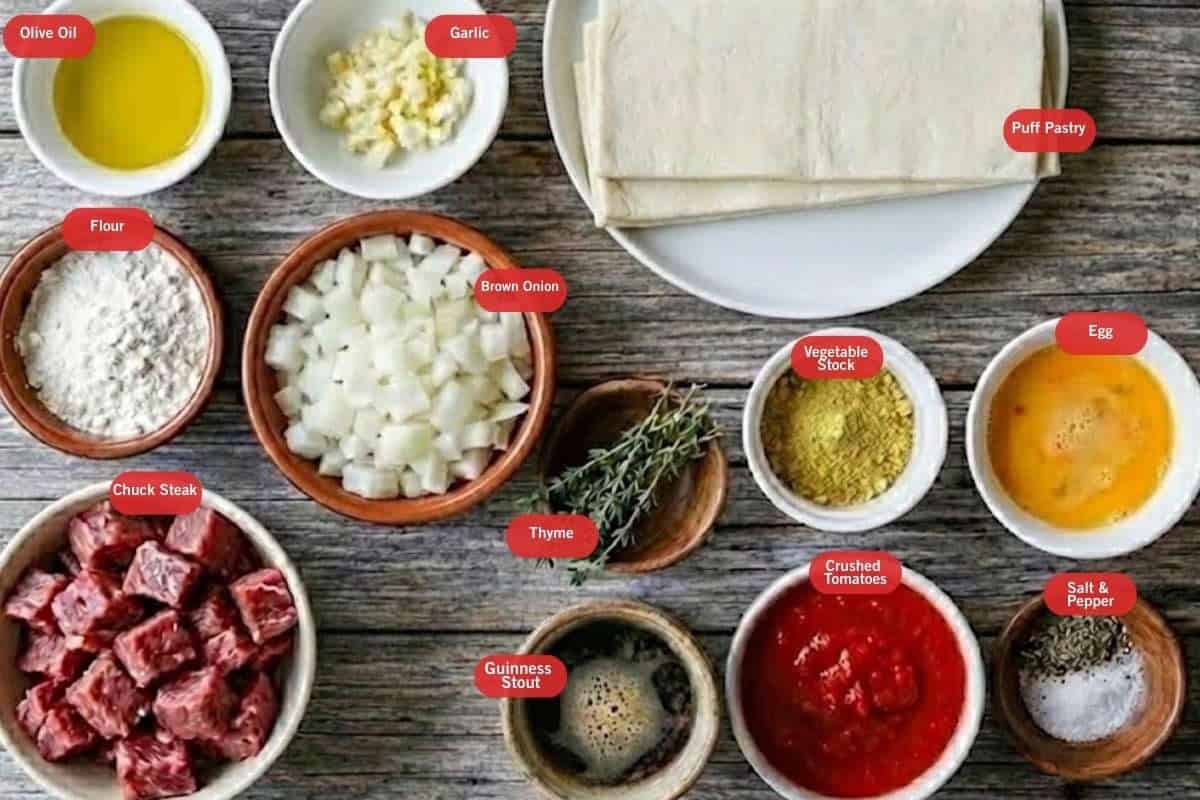 Flat lay photo of ingredient shot for slow cooker steak and gravy pies
(olive oil, garlic, puff pastry, brown onion, flour, thyme, vegetable sock, egg, chuck steak, Guinness stout, crushed tomatoes, salt and pepper) - 2