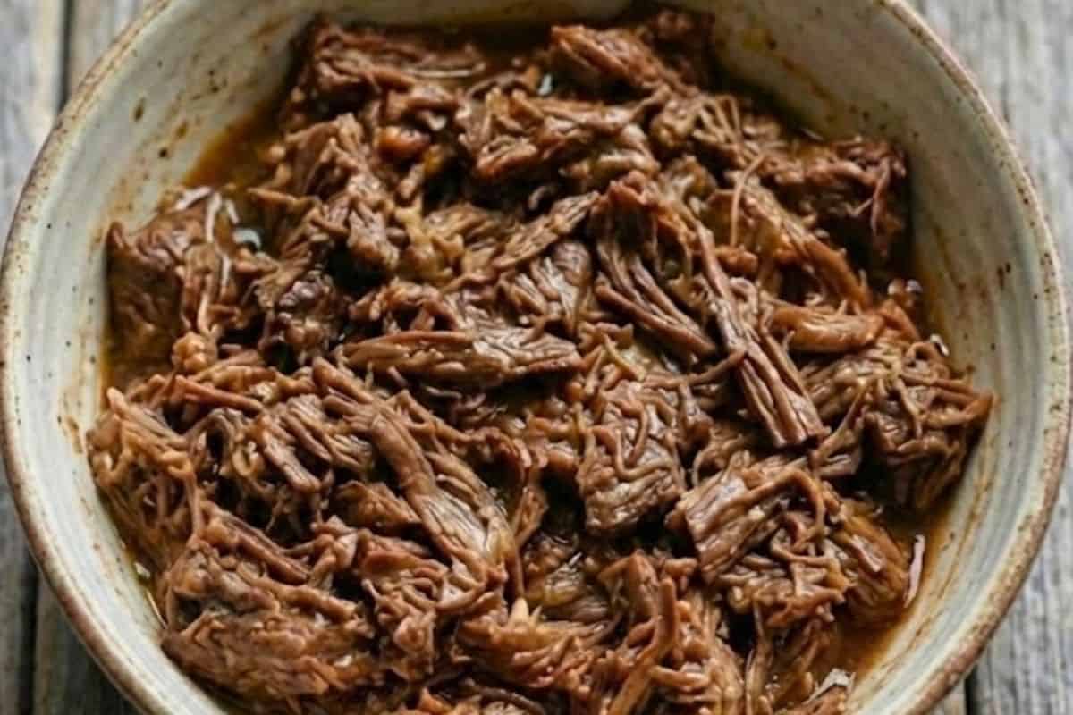 Once cooked, shred the beef gently and set aside to cool slightly. - 7