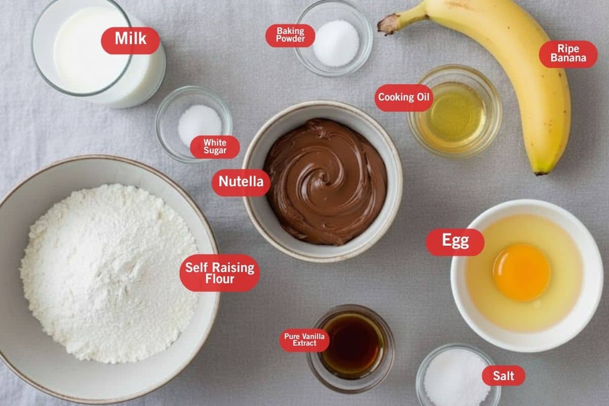 Flat lay photo of ingredient shot of milk, self raising flour, baking powder, cooking oil, ripe banana, cooking oil, egg, pure vanilla extract, salt, white sugar, nutella