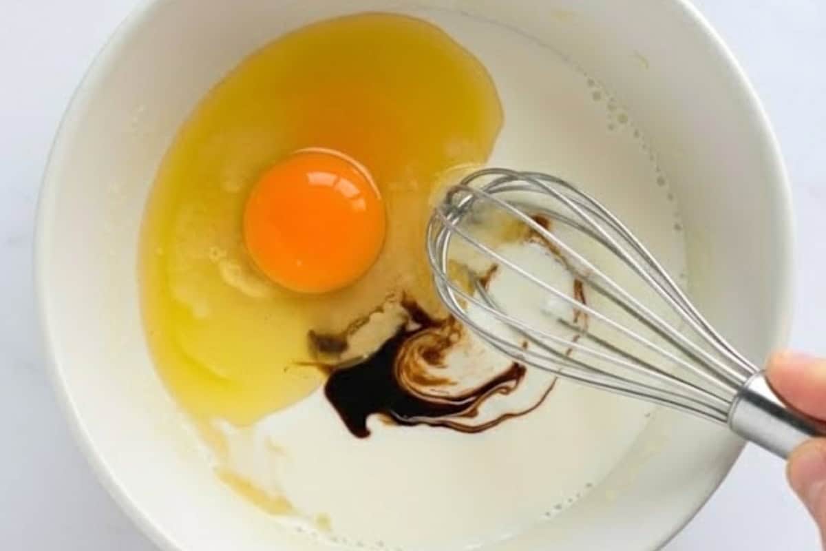 Add egg, melted butter (or oil), vanilla, and milk.