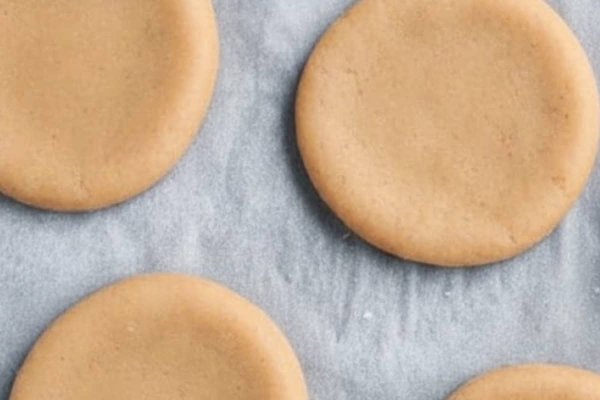 Place the shaped cookies on the prepared baking trays, - 6