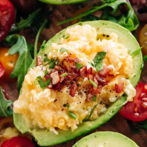 Enjoy Soft scrambled eggs with stringy cheese and crispy bacon stuffed into avocado