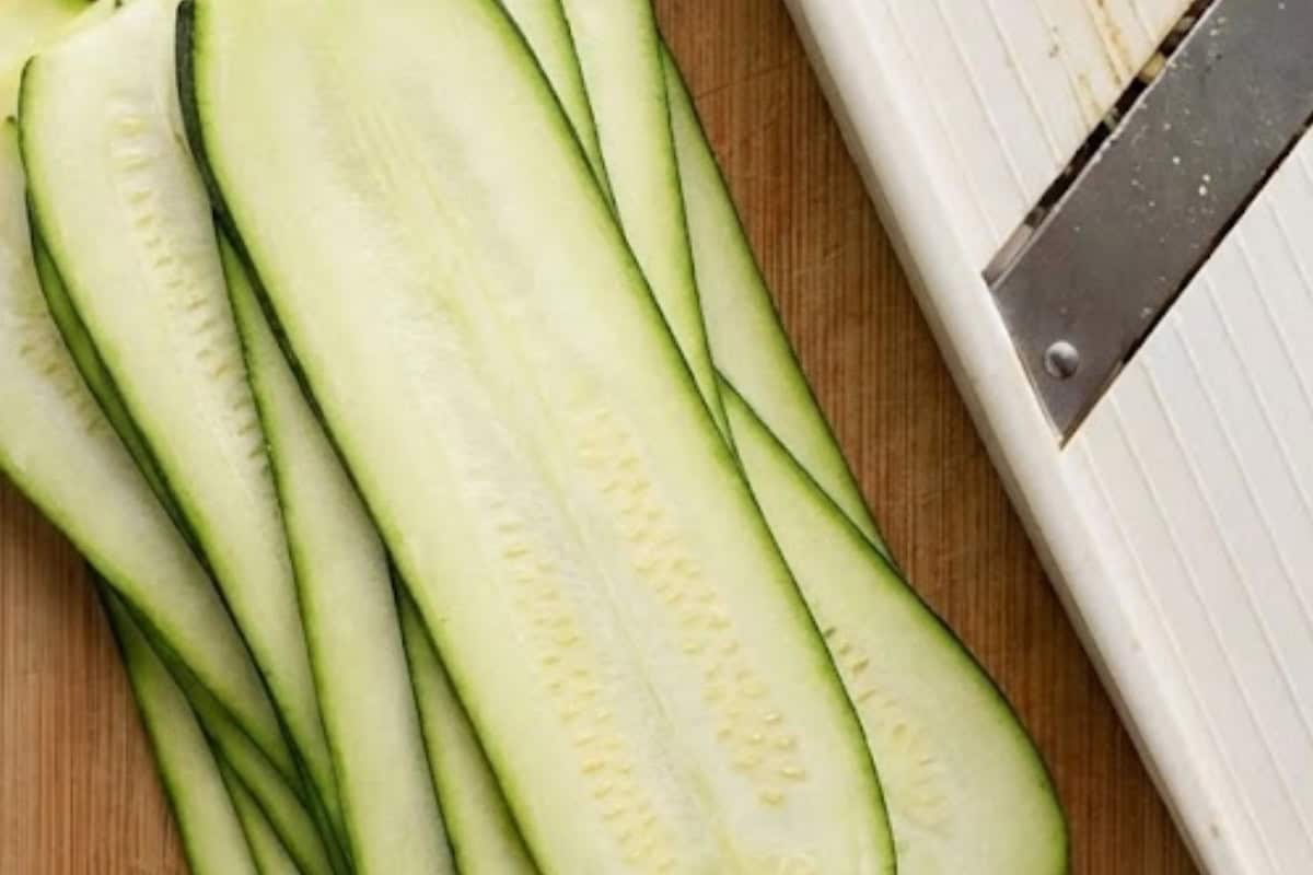 Using a mandolin,slice the zucchini lengthwise into wide ribbons. - 4