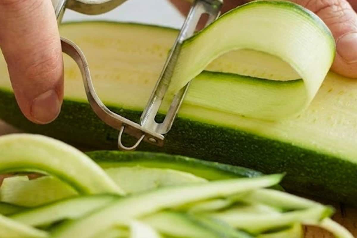 Slice zucchini in half lengthways. Using a peeler, peel ribbons down to the center and repeat. - 3