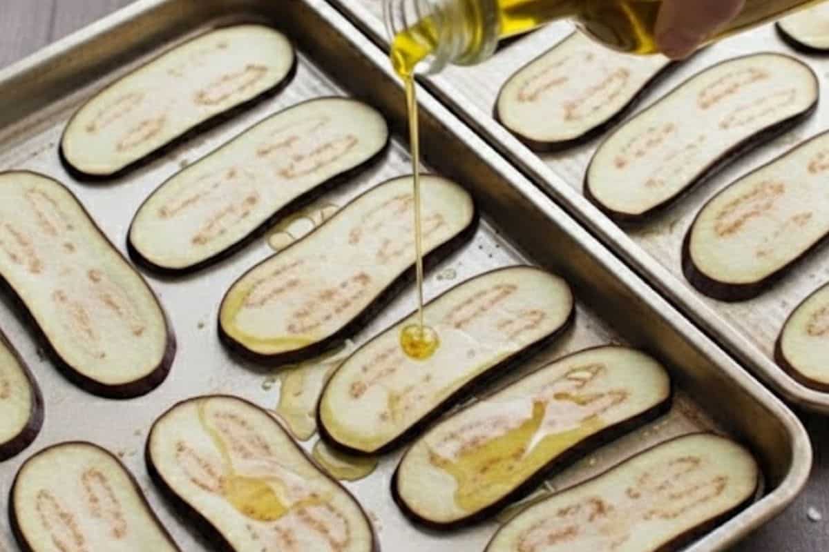 Drizzle the slices with olive oil, sprinkle with salt, and toss gently with your hands to coat each piece evenly.