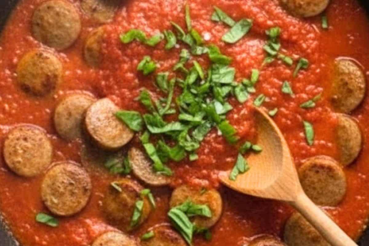 Bring the sauce to a gentle simmer, then reduce the heat to low. Season with salt, sugar, stock powder, and chopped basil.