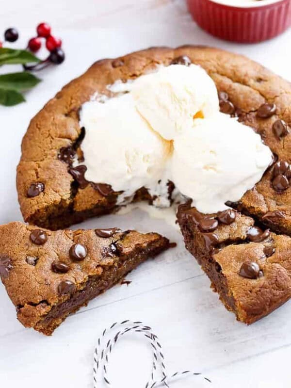 Nutella Stuffed Deep Dish Gingerbread Cookie with Browned Butter and Chocolate Chips with some ice cream scoops