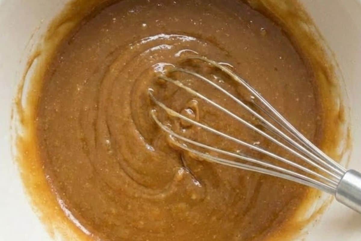 In a separate bowl, whisk the cooled browned butter with the sugars until smooth, then mix in the egg and golden syrup until blended. - 6