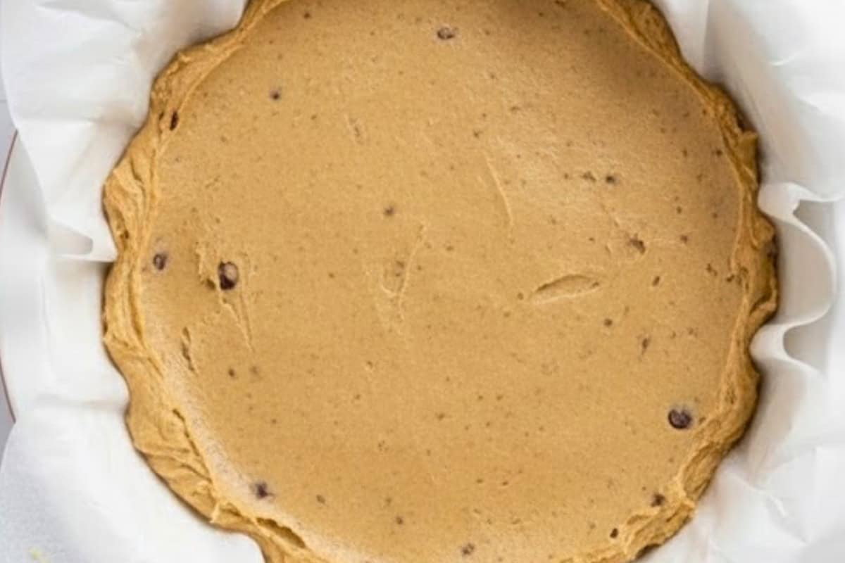 Spoon half of the dough into the prepared pan and smooth it out into an even layer, pressing lightly with the back of a spoon. - 8