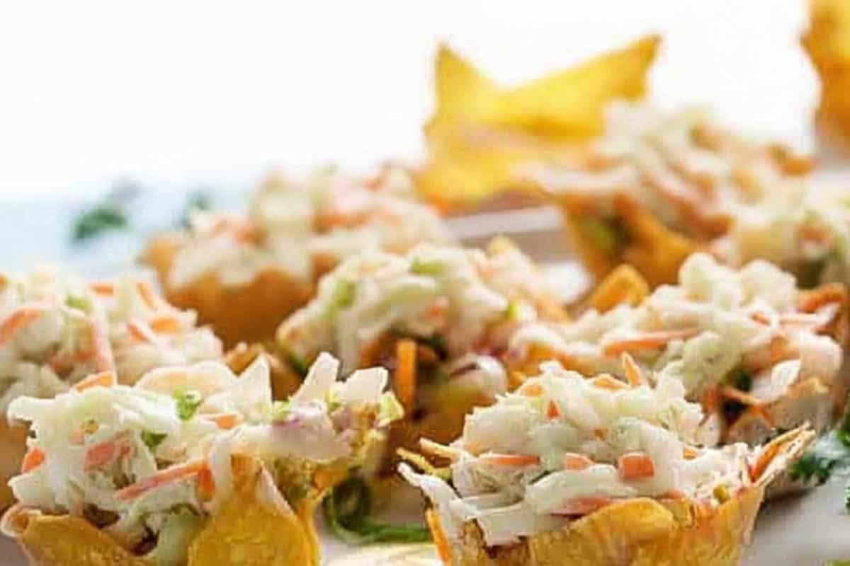 Filling the wonton cup with the salad mixture. - 8