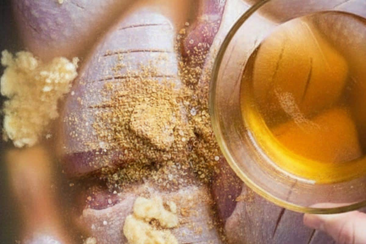 Pouring the beer over the turkey with crushed garlic, stock powder, and salt.