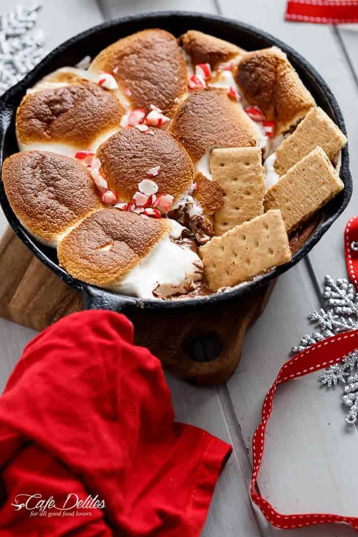 A Candy Cane Christmas S'mores Dip made with only 3 ingredients and in under 10 minutes! Kids and adults alike will devour this at Christmas time! | http://cafedleites.com