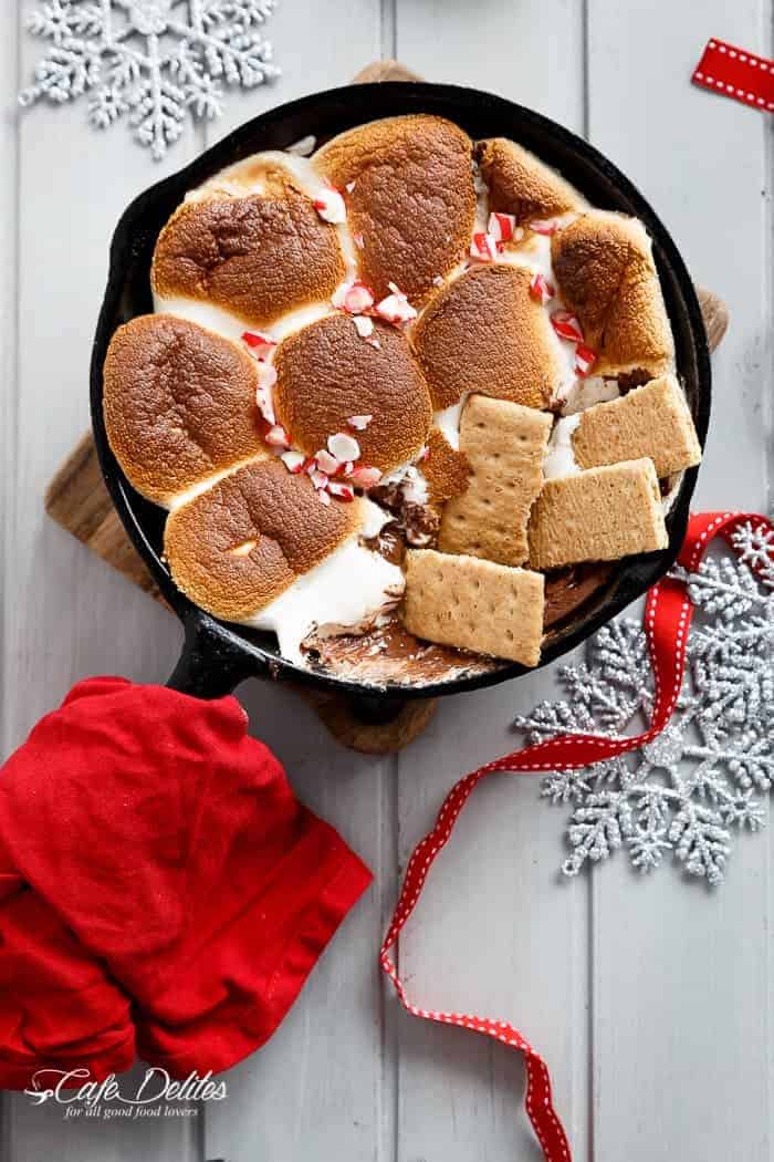 A Candy Cane Christmas S'mores Dip made with only 3 ingredients and in under 10 minutes! Kids and adults alike will devour this at Christmas time! | http://cafedleites.com