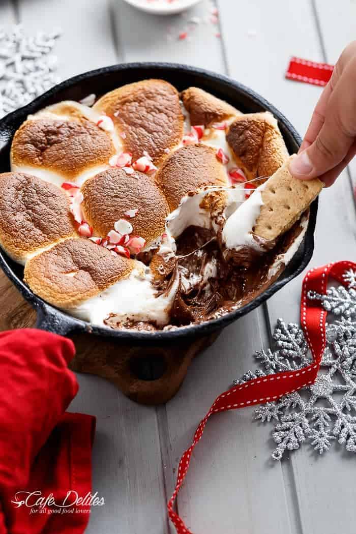 A Candy Cane Christmas S'mores Dip made with only 3 ingredients and in under 10 minutes! Kids and adults alike will devour this at Christmas time! | http://cafedleites.com