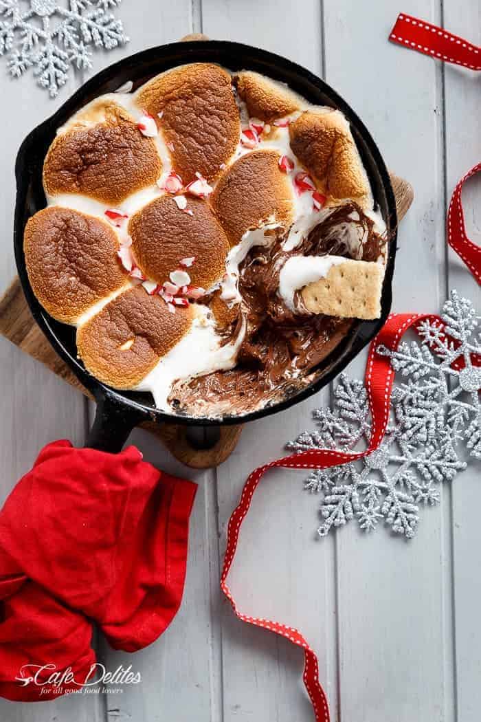 A Candy Cane Christmas S'mores Dip made with only 3 ingredients and in under 10 minutes! Kids and adults alike will devour this at Christmas time! | http://cafedleites.com