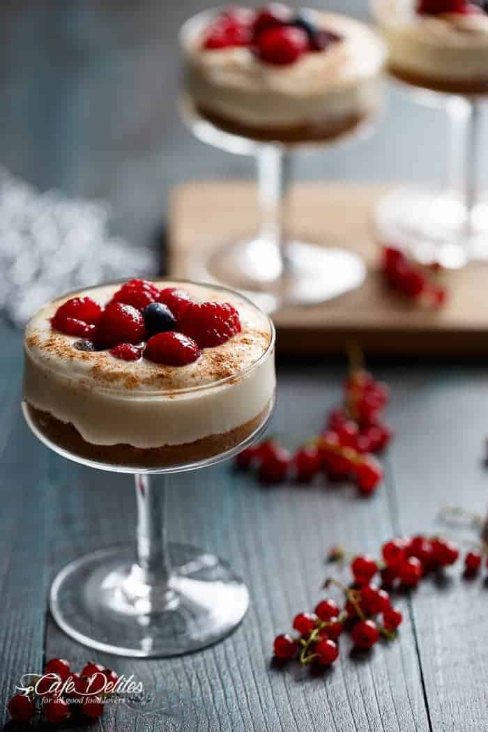 With a gingerbread cookie base and sugared berries as a topping, these mini no bake eggnog cheesecakes -- parfaits or trifles -- will get you through Christmas and future Thanksgiving dinners | https://cafedelites.com