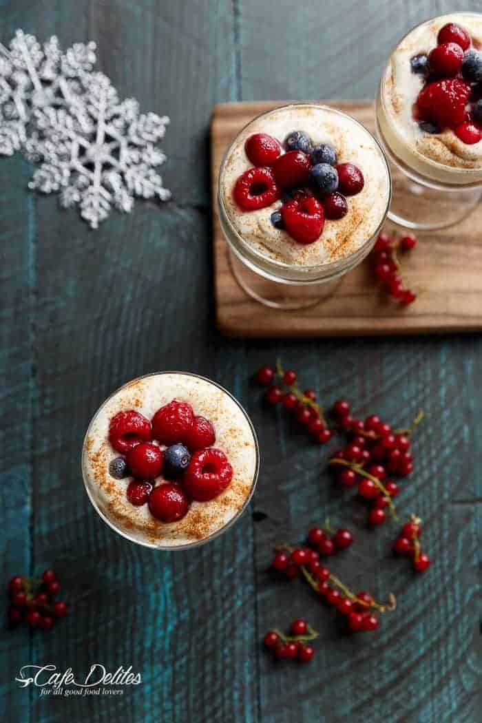 With a gingerbread cookie base and sugared berries as a topping, these mini no bake eggnog cheesecakes -- parfaits or trifles -- will get you through Christmas and future Thanksgiving dinners | https://cafedelites.com