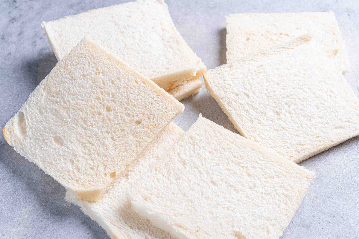 An image of flattened white bread slices without crusts.